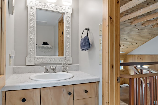 bathroom with wood ceiling, lofted ceiling with beams, and vanity