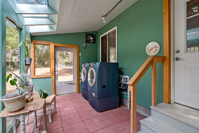 washroom featuring a skylight and washer and dryer