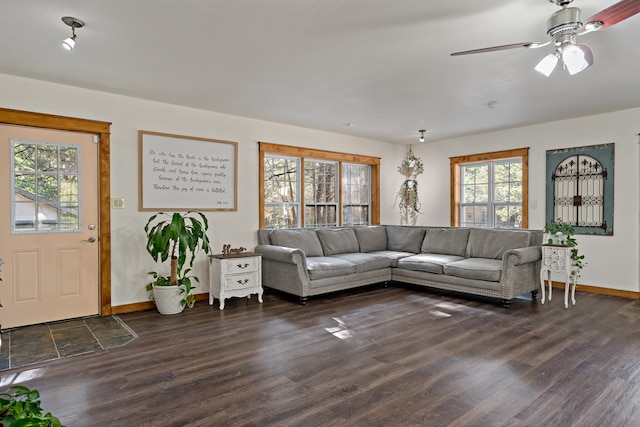 living room featuring ceiling fan and dark hardwood / wood-style floors