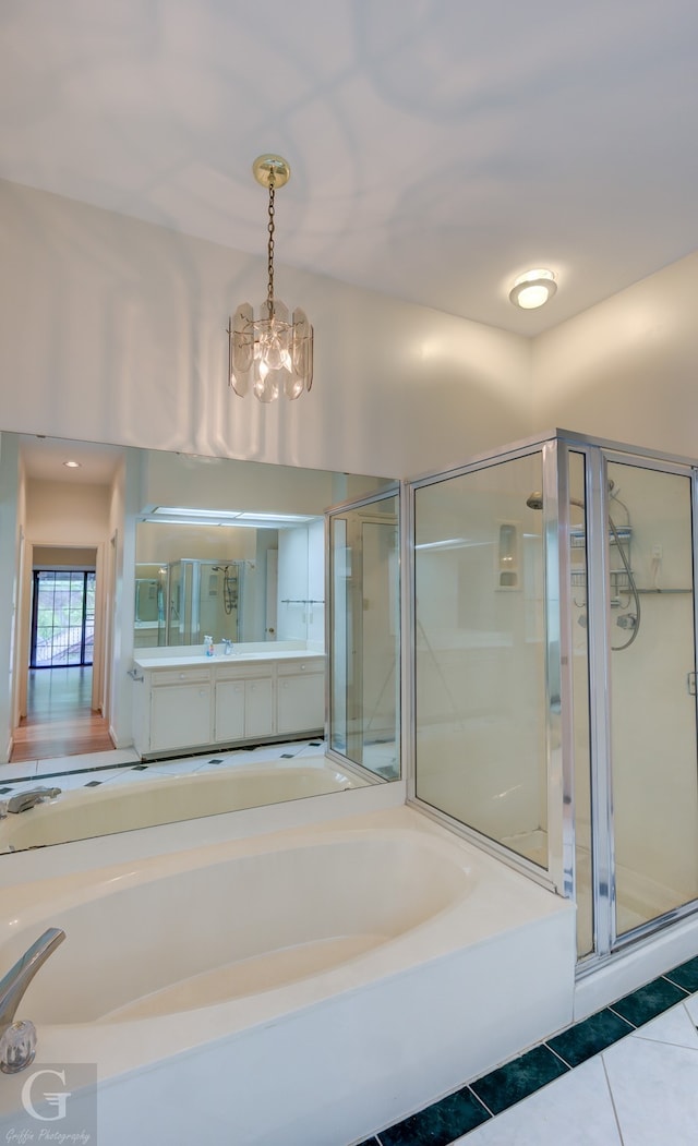 bathroom featuring independent shower and bath, vanity, a chandelier, and tile patterned flooring