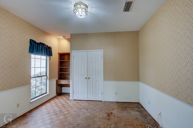 unfurnished bedroom with parquet floors