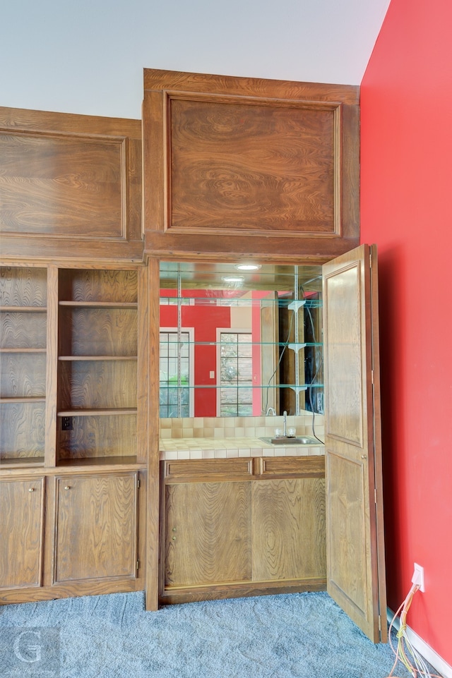 interior space with carpet and indoor wet bar