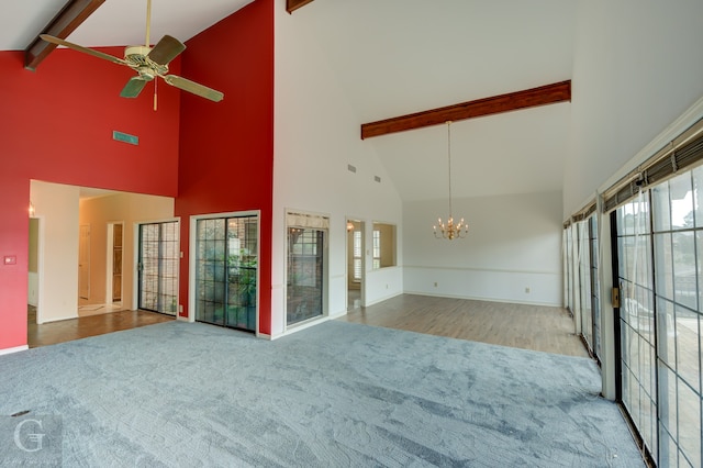 unfurnished room featuring ceiling fan with notable chandelier, hardwood / wood-style flooring, high vaulted ceiling, and beamed ceiling