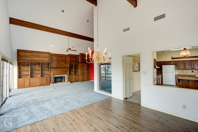 living room with plenty of natural light, hardwood / wood-style floors, and high vaulted ceiling