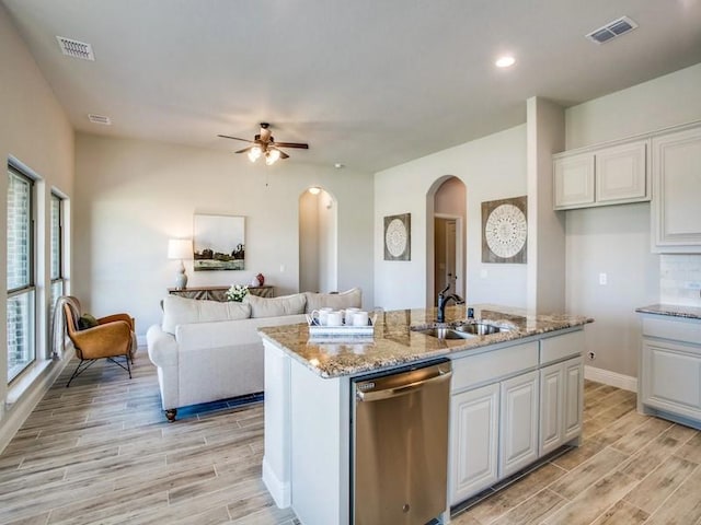 kitchen with sink, an island with sink, white cabinetry, and stainless steel dishwasher