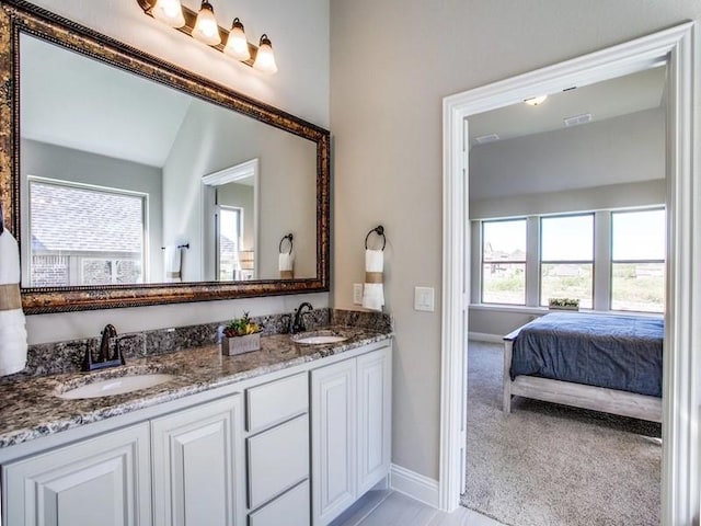 bathroom with vanity and vaulted ceiling