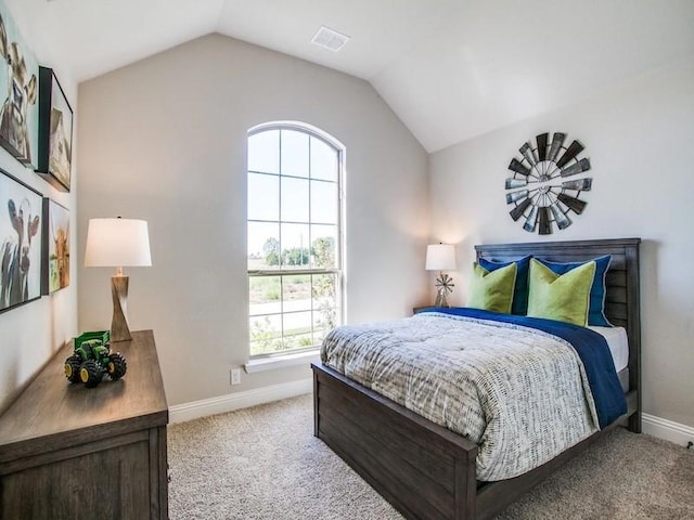 bedroom featuring light colored carpet and lofted ceiling