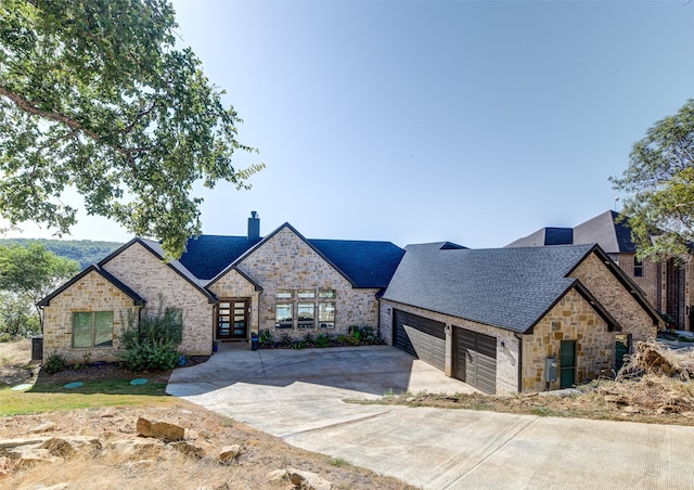 french provincial home featuring a garage