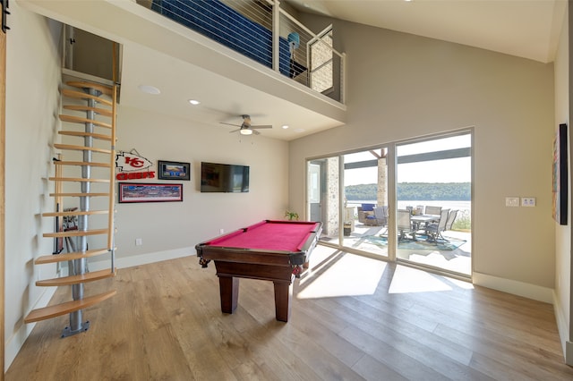 game room with billiards, ceiling fan, a high ceiling, and light wood-type flooring