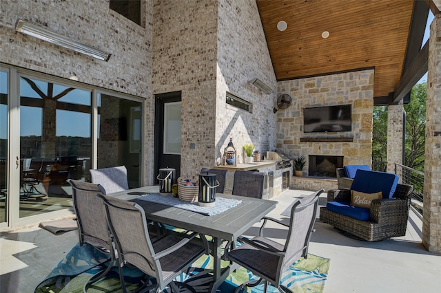 view of patio featuring an outdoor stone fireplace