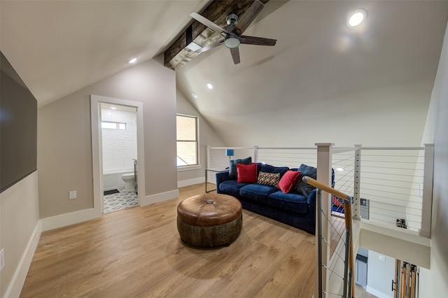 sitting room featuring ceiling fan, vaulted ceiling, and light wood-type flooring