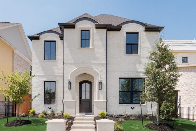 french provincial home featuring a front lawn