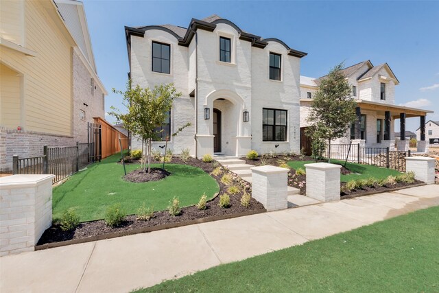 french provincial home featuring a front yard