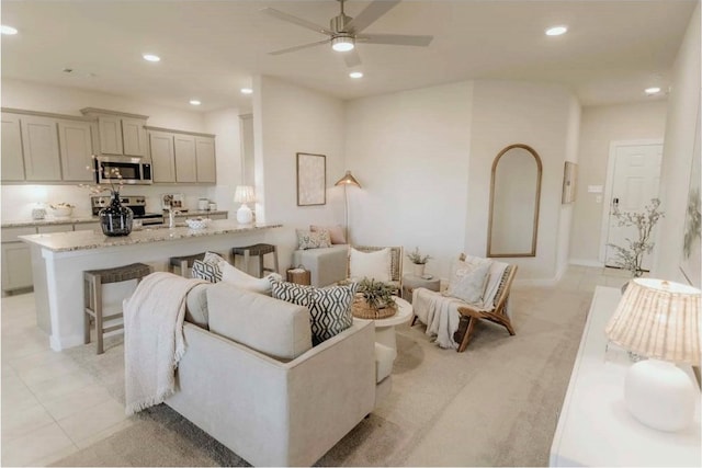 tiled living room with ceiling fan