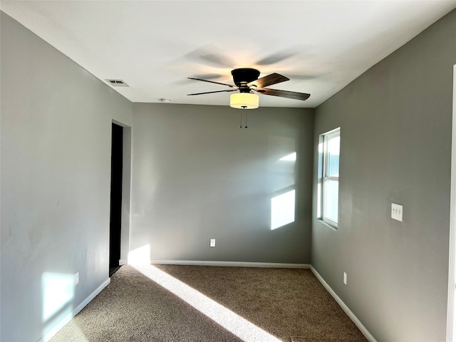 carpeted empty room featuring ceiling fan