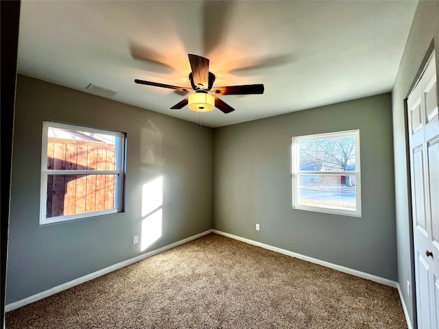 unfurnished room featuring carpet floors and ceiling fan