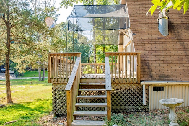 deck featuring a trampoline and a lawn