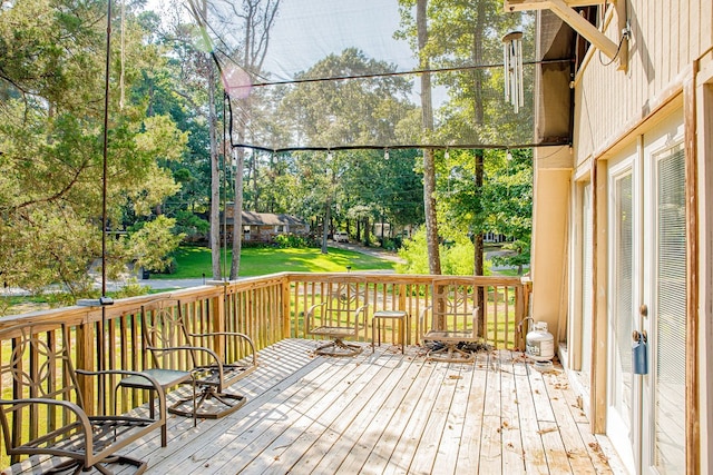 wooden terrace with a lawn