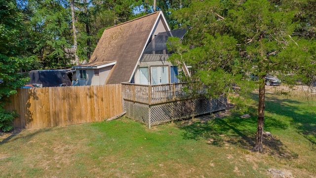 view of property exterior featuring a yard and a deck