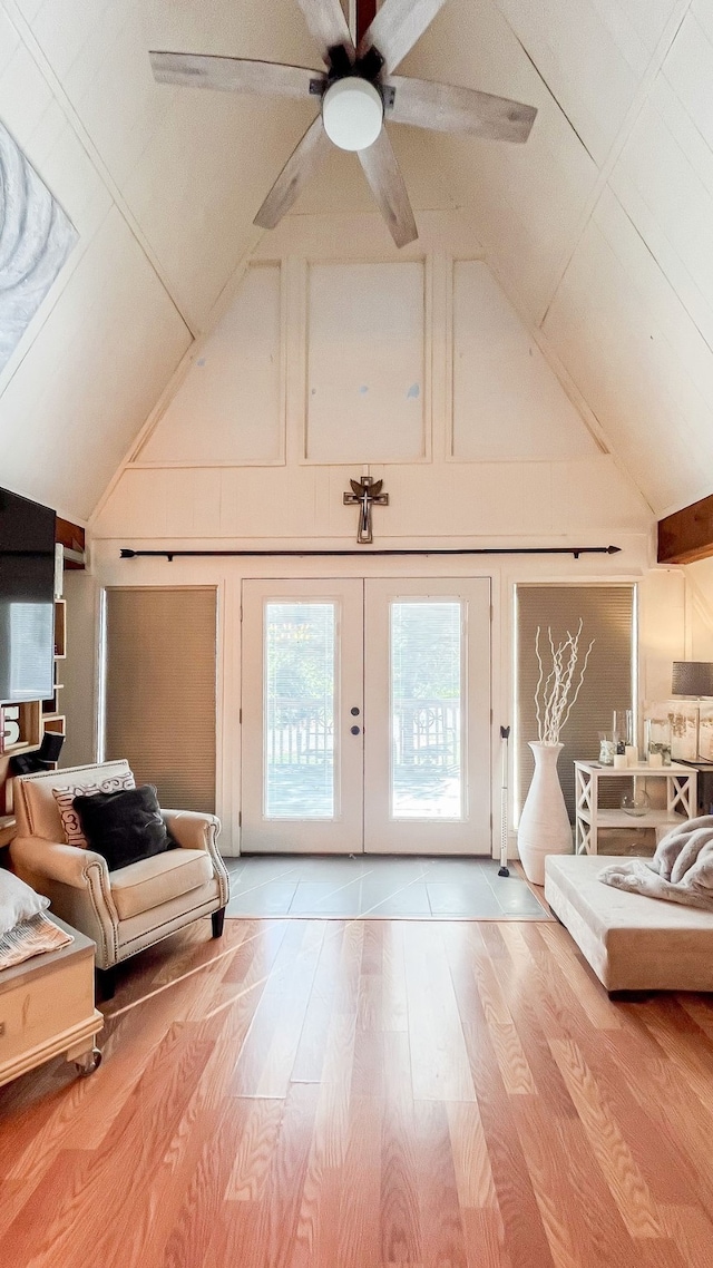 additional living space with ceiling fan, vaulted ceiling, light hardwood / wood-style flooring, and french doors