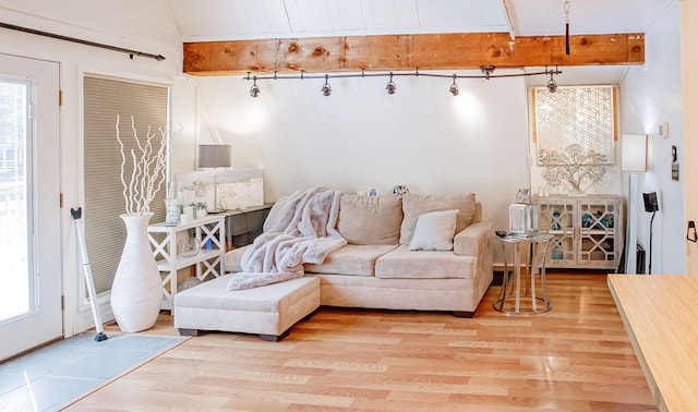 living room featuring light hardwood / wood-style floors and vaulted ceiling with beams