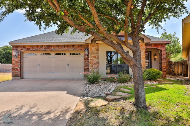 view of front of home featuring a garage and a front yard