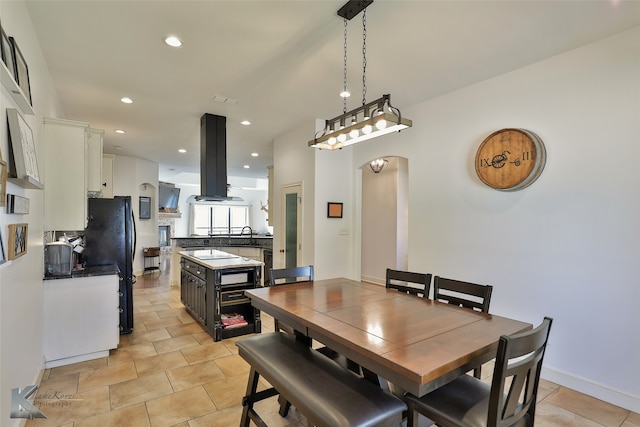 dining room with sink and light tile patterned floors