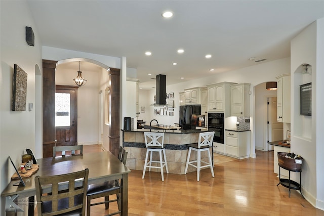 dining area with light wood-type flooring and sink