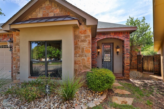 doorway to property with a garage