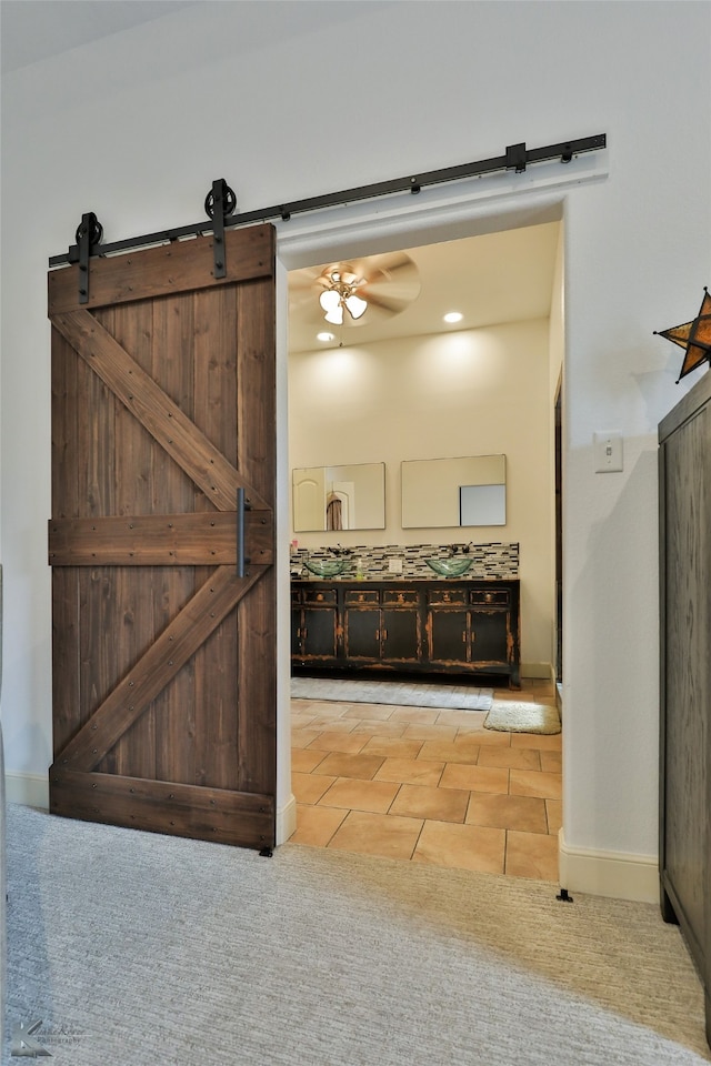 interior space with ceiling fan and tile patterned floors