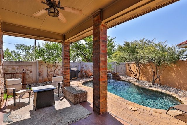 view of patio with ceiling fan, pool water feature, and a fenced in pool