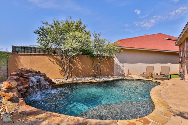 view of pool with pool water feature and a patio area