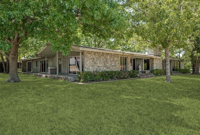 view of front of property with stone siding and a front yard