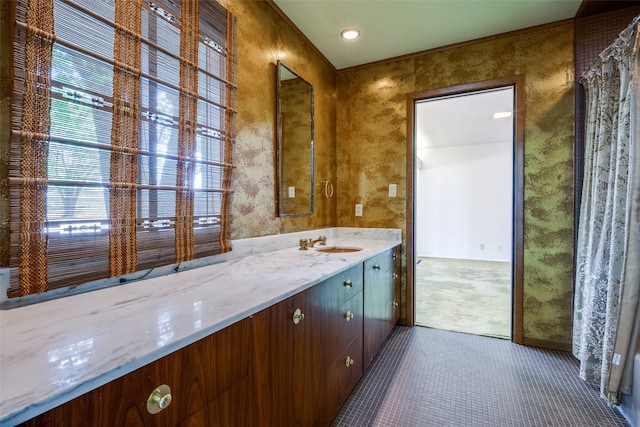 bathroom featuring a wealth of natural light, tile patterned flooring, and vanity