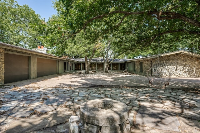 back of property with a garage