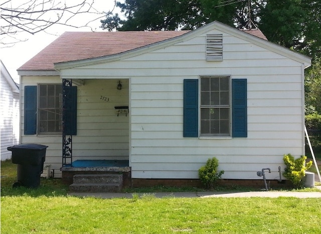 view of outbuilding with a lawn