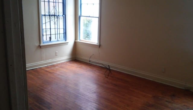 unfurnished room featuring hardwood / wood-style flooring