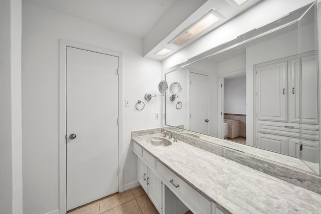 bathroom with tile patterned flooring and vanity