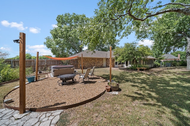 view of yard with a hot tub