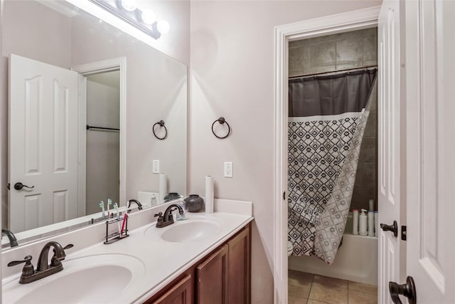 full bath featuring tile patterned floors, shower / bathtub combination with curtain, double vanity, and a sink