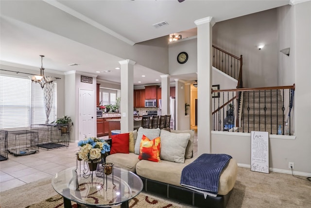 living area featuring visible vents, ornamental molding, stairway, baseboards, and ornate columns