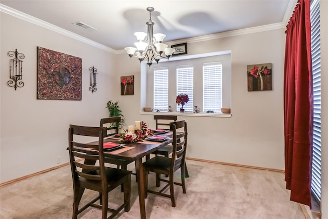 dining room with baseboards, visible vents, ornamental molding, a notable chandelier, and light colored carpet