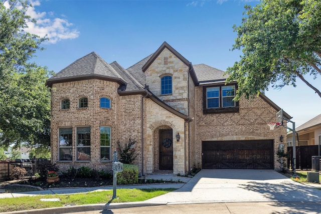 french country style house featuring a garage