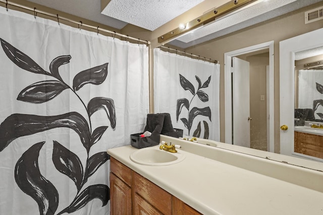 bathroom with vanity and a textured ceiling