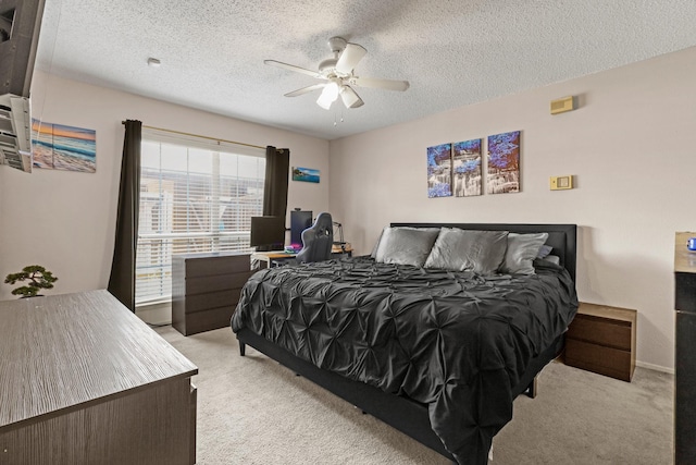 bedroom featuring ceiling fan, light carpet, and a textured ceiling