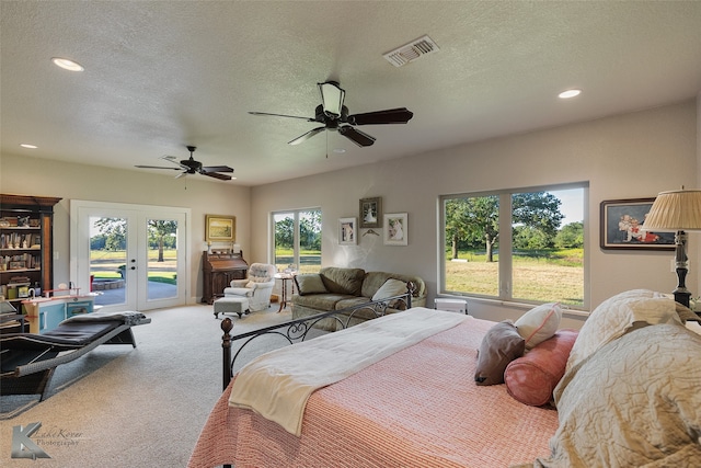 carpeted bedroom featuring ceiling fan, a textured ceiling, french doors, and access to exterior