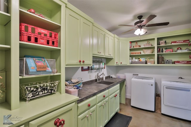 laundry room with ceiling fan, sink, washer and clothes dryer, and cabinets