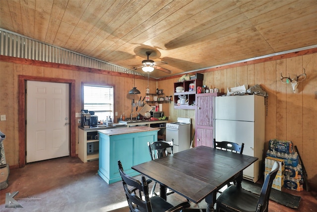 kitchen with ceiling fan, white fridge, wooden ceiling, and wooden walls