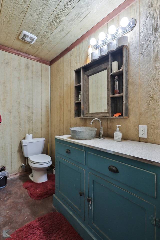 bathroom with wood ceiling, toilet, wooden walls, and vanity