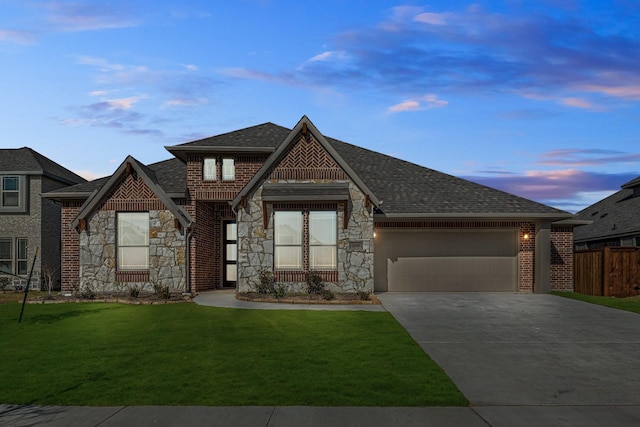 view of front of property with a lawn and a garage